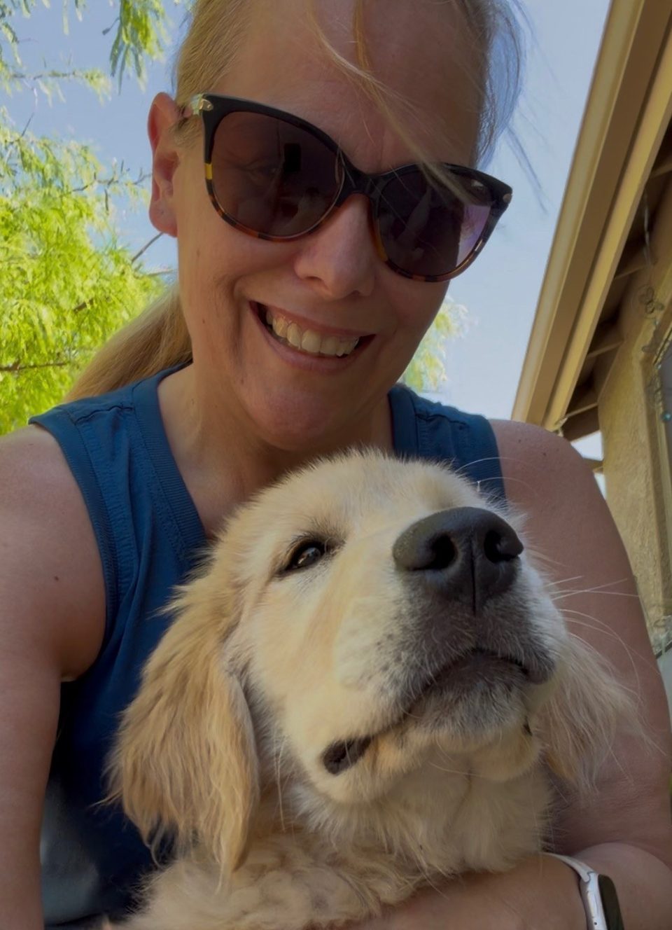 Cindy with a golden retriever puppy